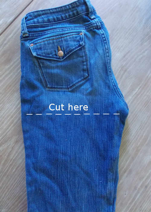image of blue jeans with a line showing where to cut the fabric