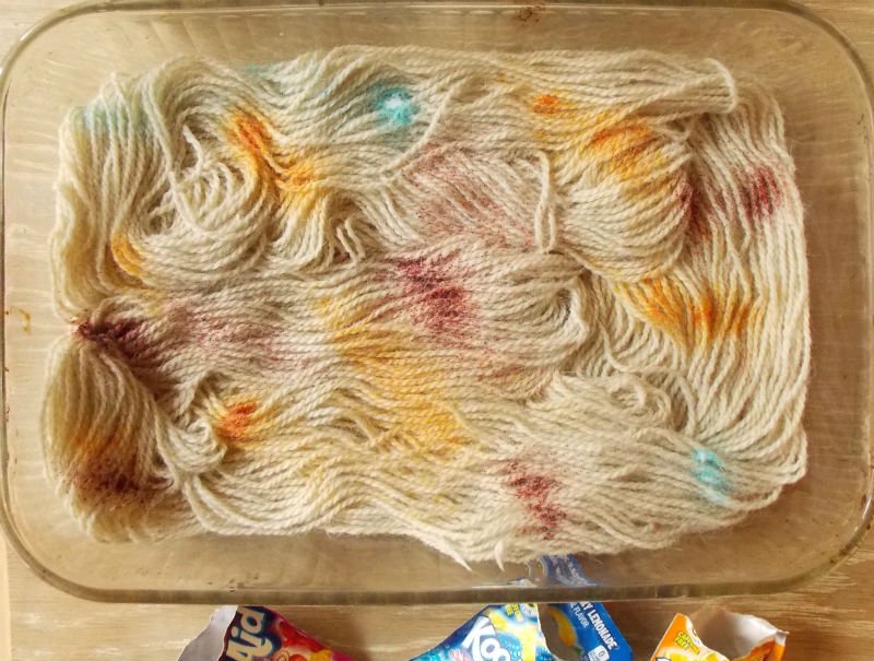 Sprinkle the Kool Aid Powder on the damp wool yarn
