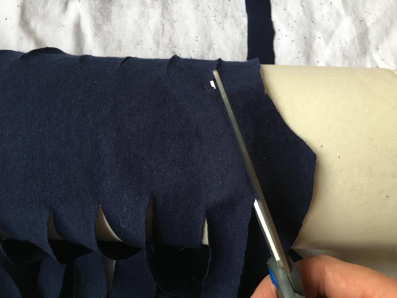 Cutting the second strip of the tee shirt yarn