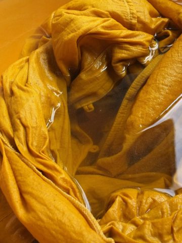 fabric being dyed yellow